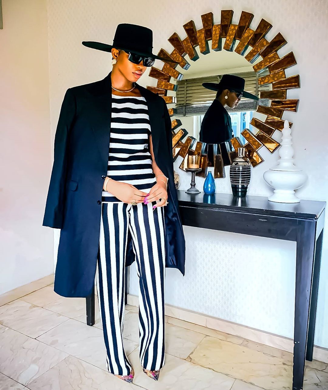 Angel Obasi striped suit with overcoat and hat