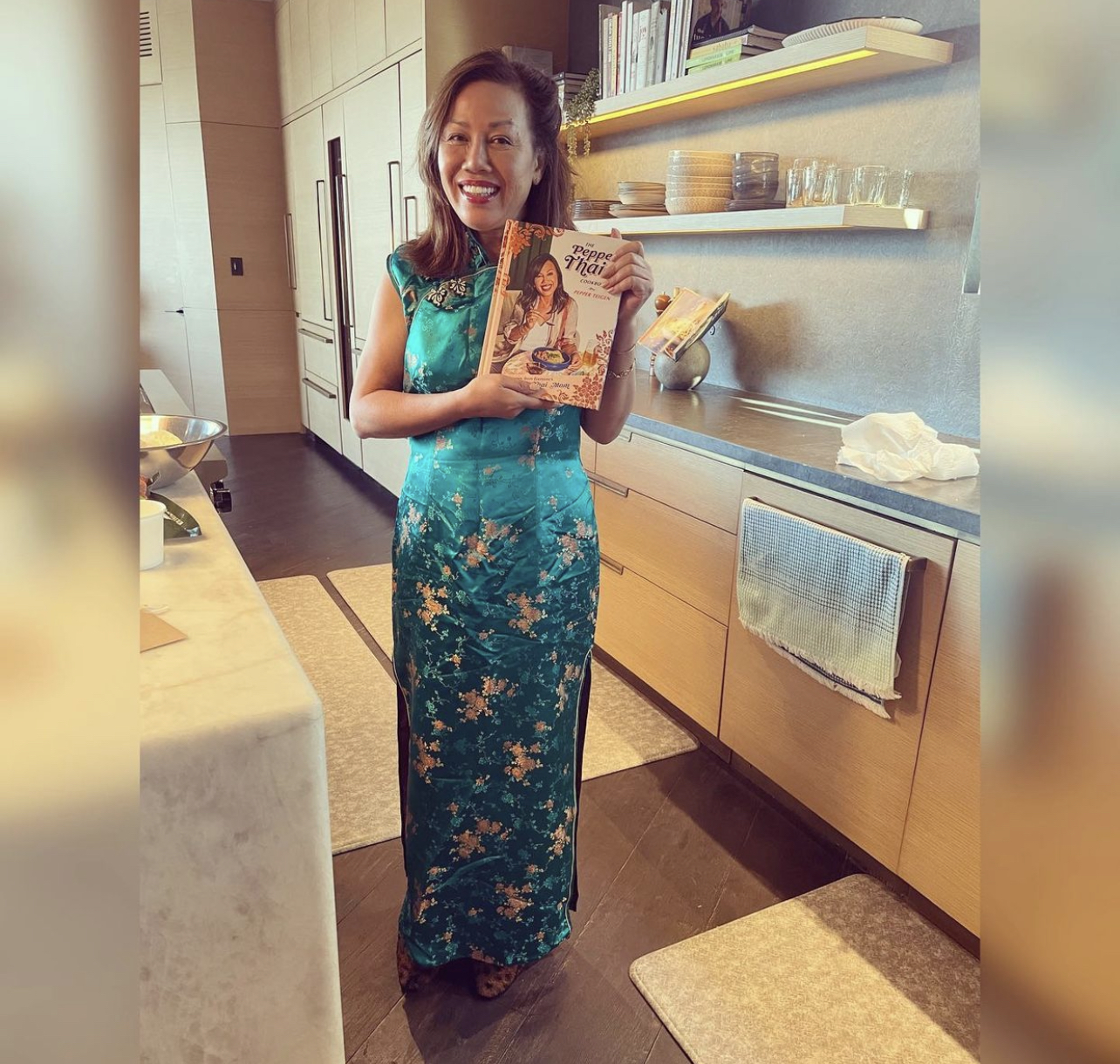 pepper vilailuck teigen shows off her cooking book The Pepper Thai Cookbook: Family Recipes From Everyone’s Favorite Thai Mom