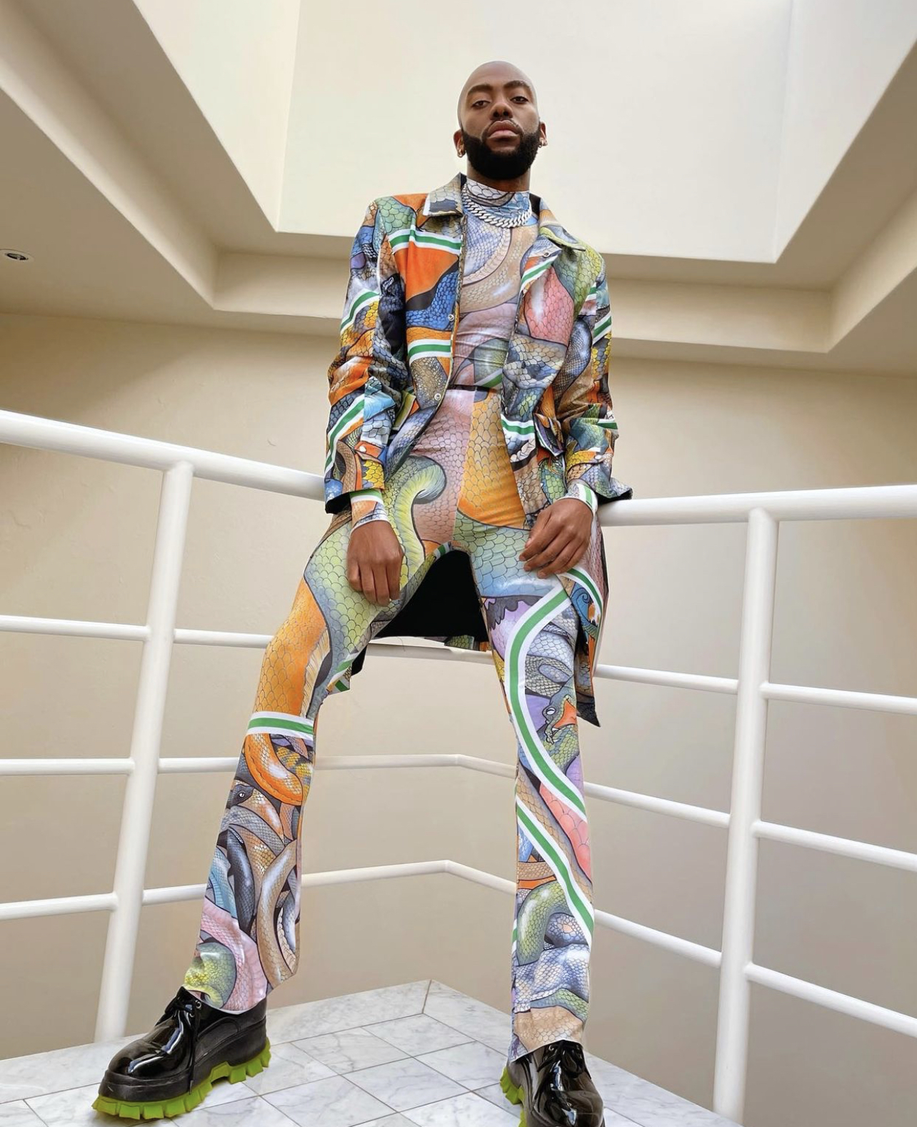 rich mnisi posing in outfit for latest news in fashion style 2021