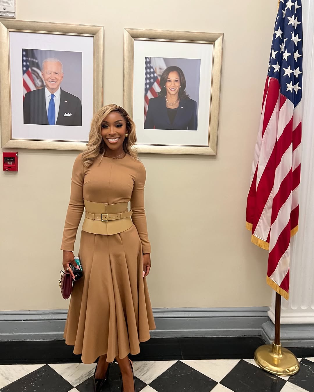 Woman with a brown top with long sleeves and midi skirt for office clothing