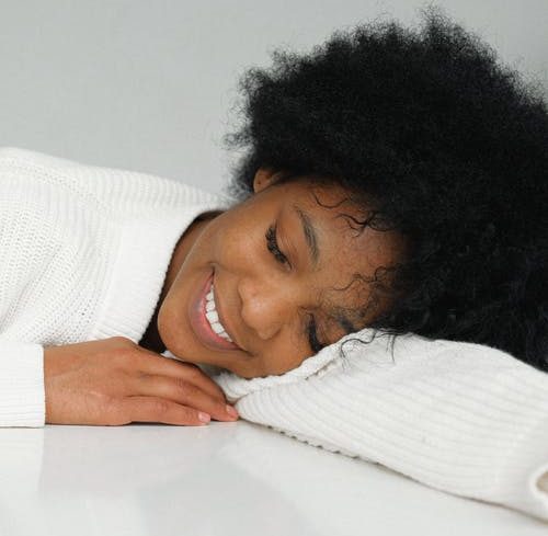black woman resting and laying down happy