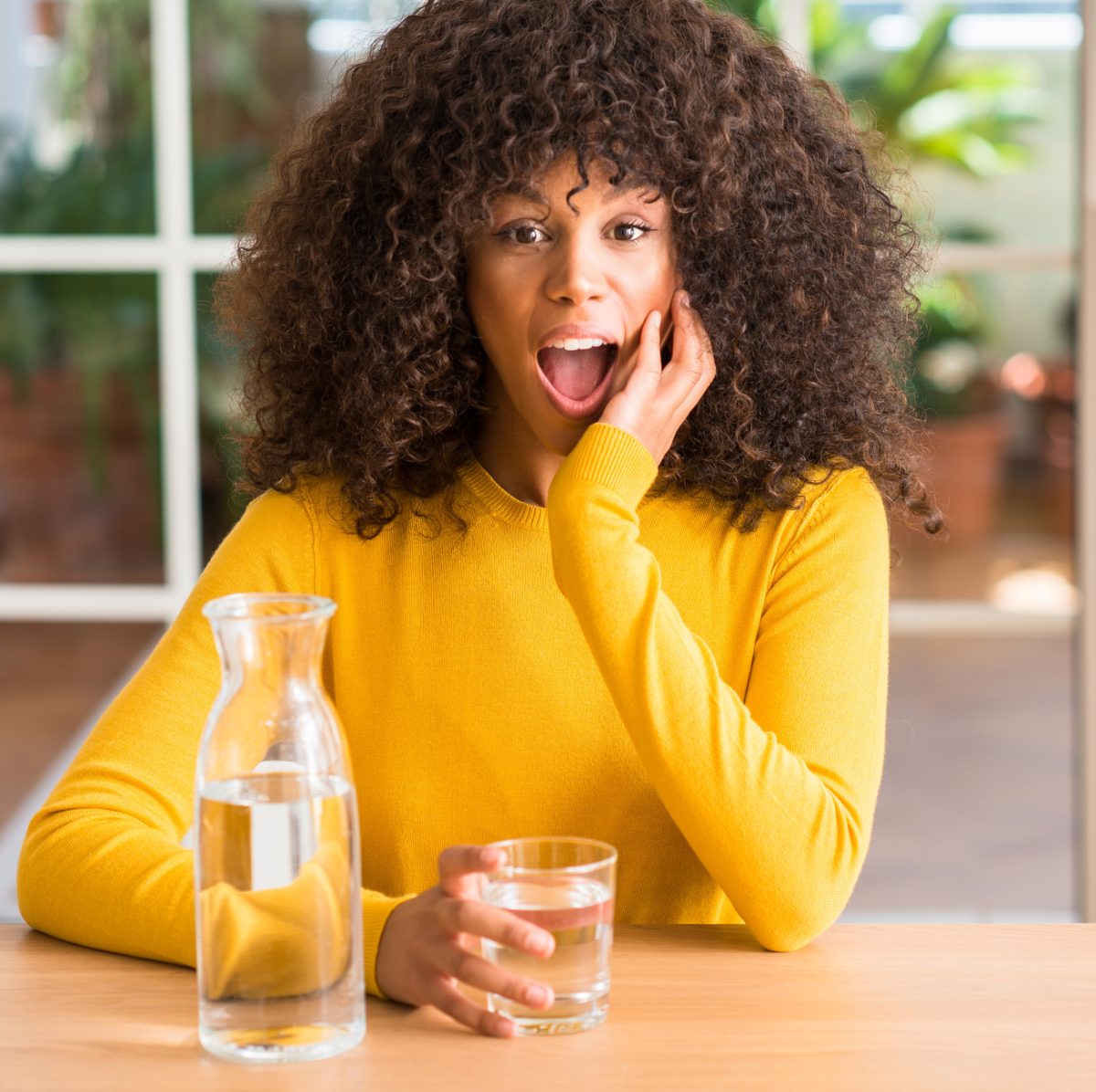 young-woman-asking-what-is-structured-water-drinking-water-in-glass