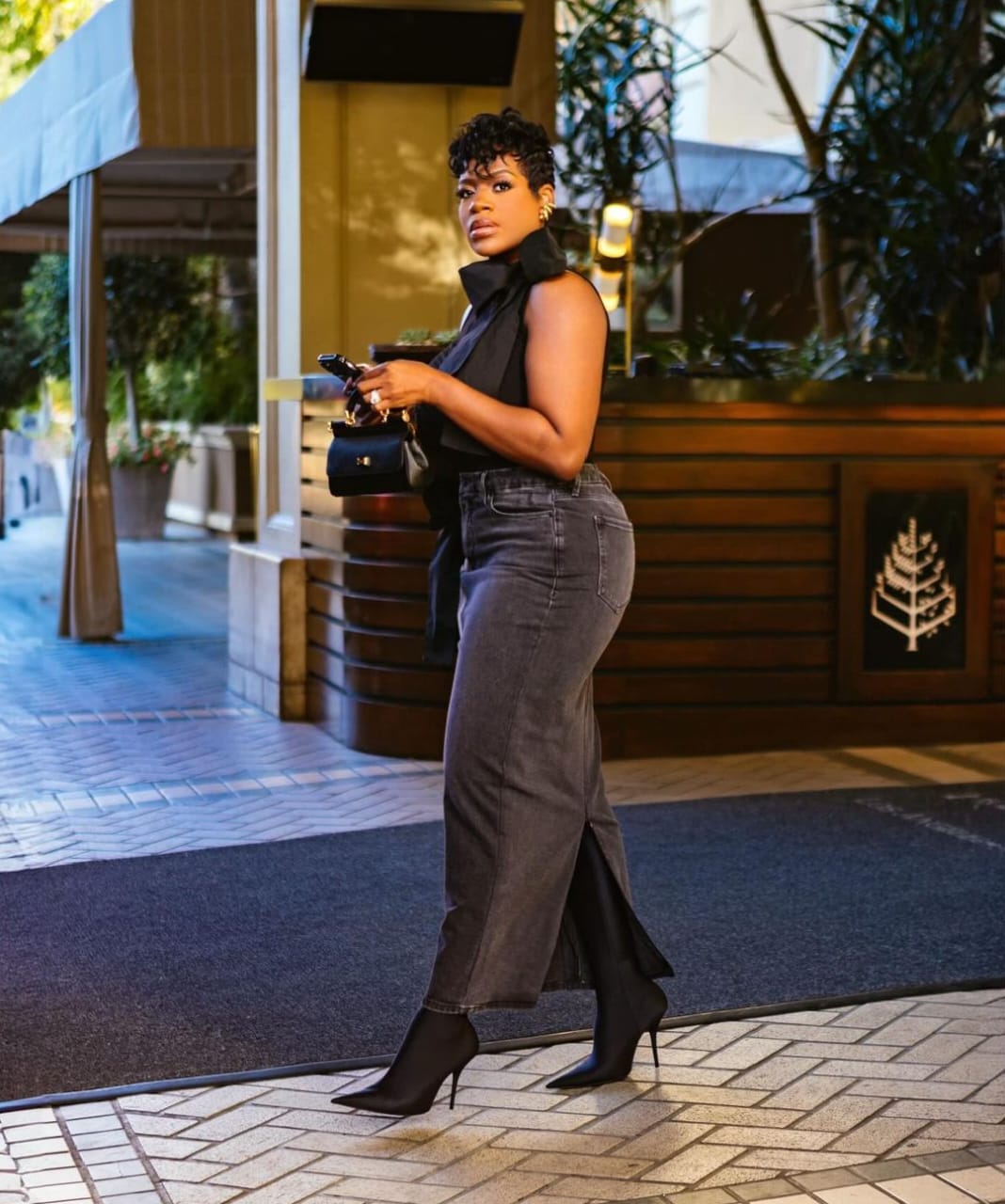 Fantasia is wearing a dark gray denim-for-2024-fall denim skirt