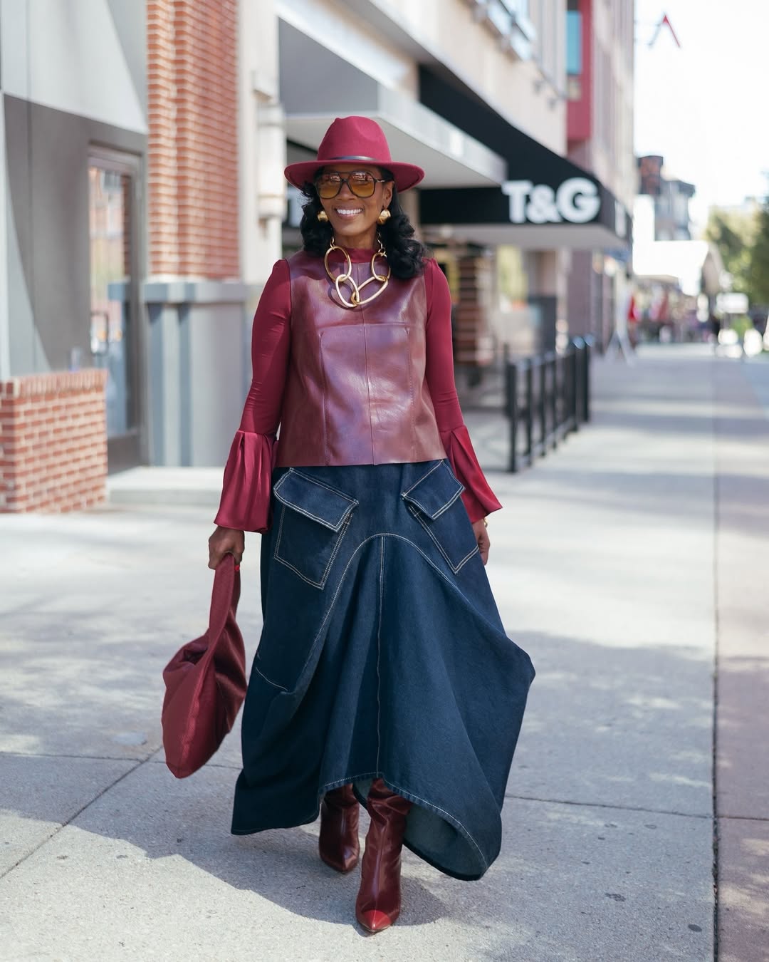 Woman wears maxi freight skirt with a leather top and hat