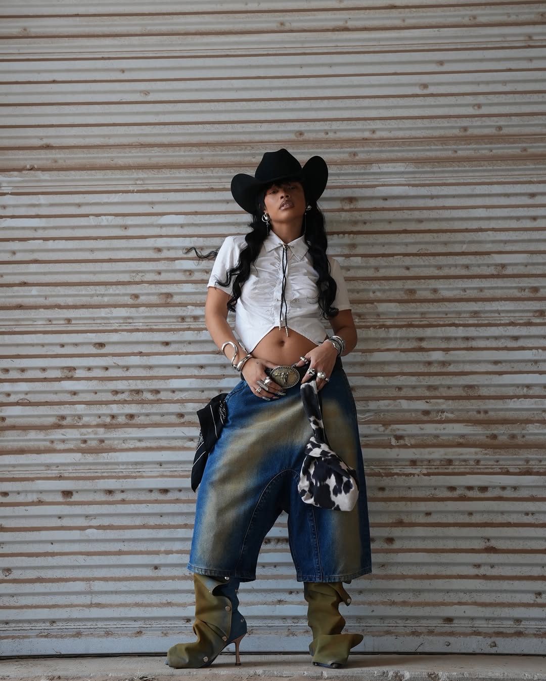 woman wearing denim shorts and crop top outfit for cowboy carter tour
