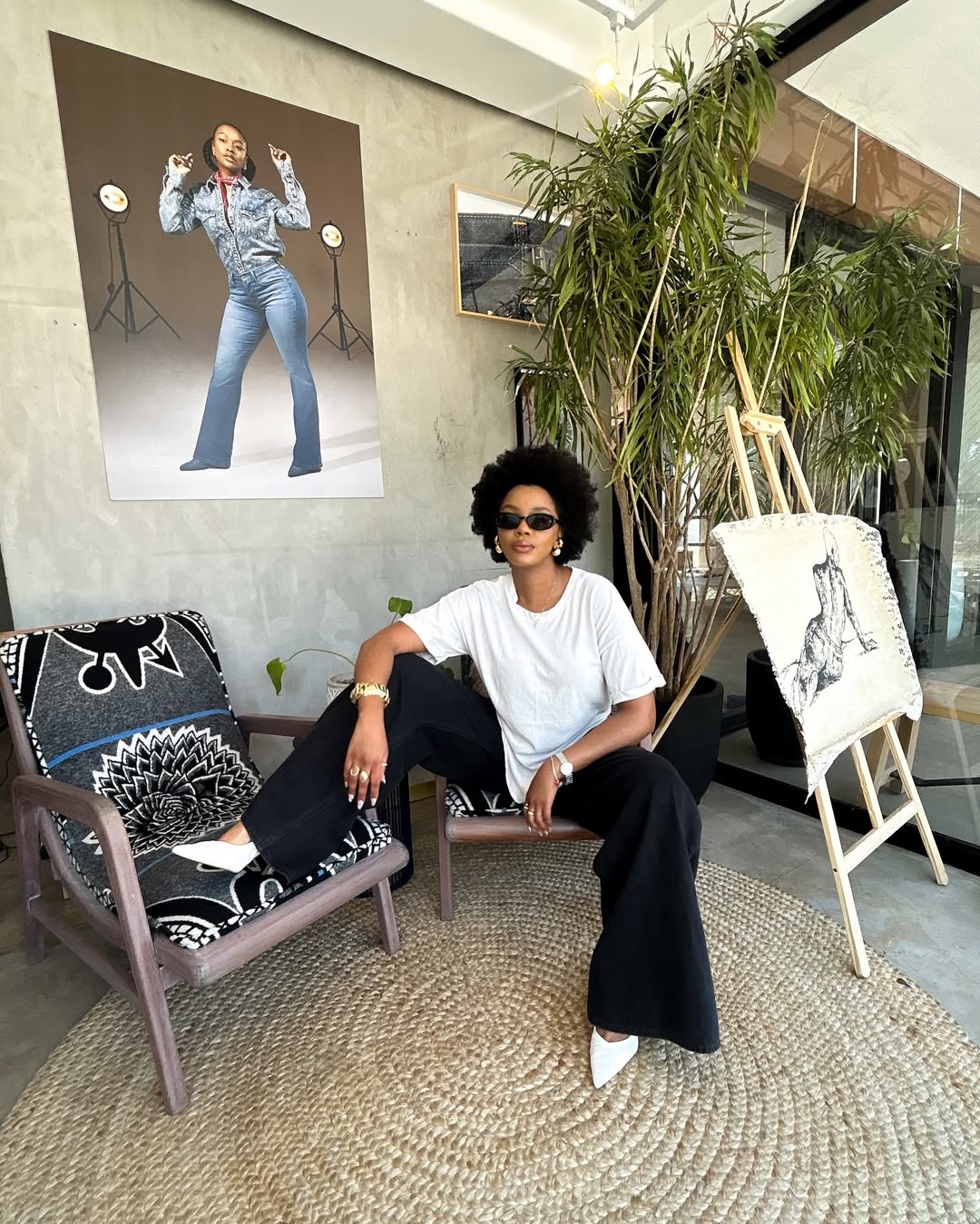 woman sitting wearing white polo and jeans