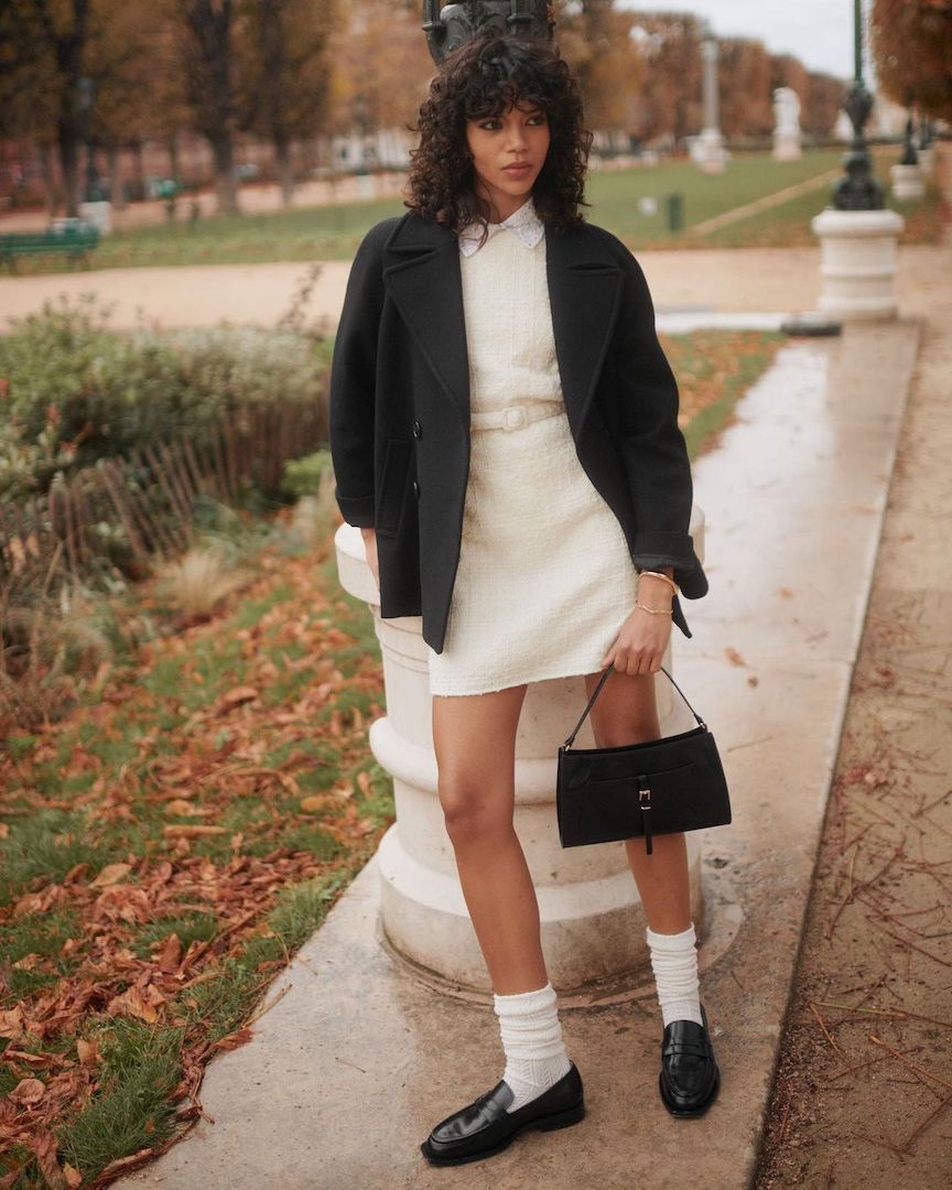 woman wearing black blazer and white mini dress with loafers
