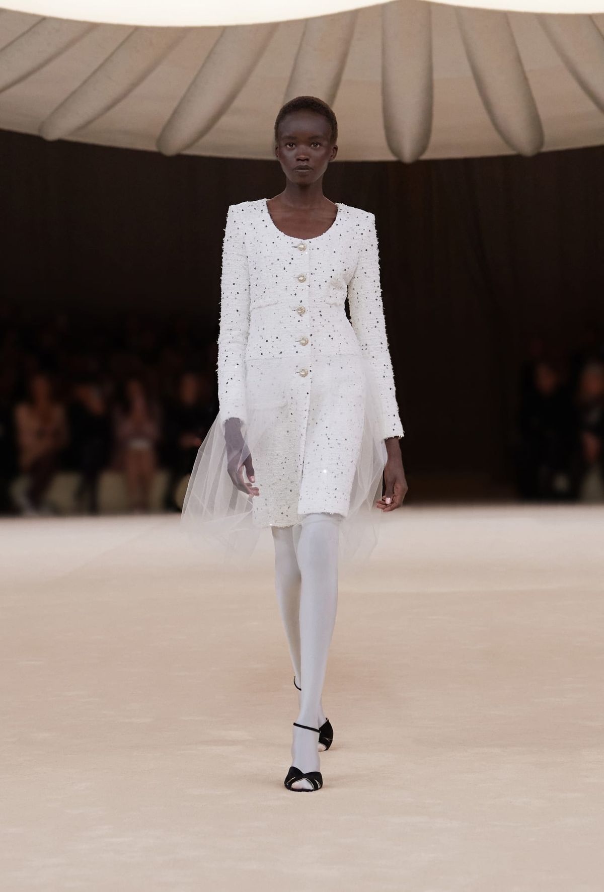 woman wearing white mini blazer dress with white tights and black shoes